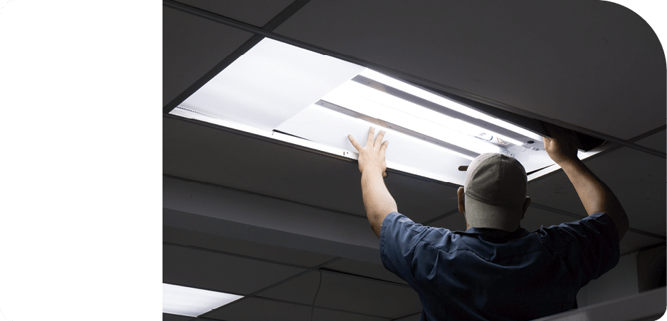 The man checking or changing Fluorescent light tube in the building.